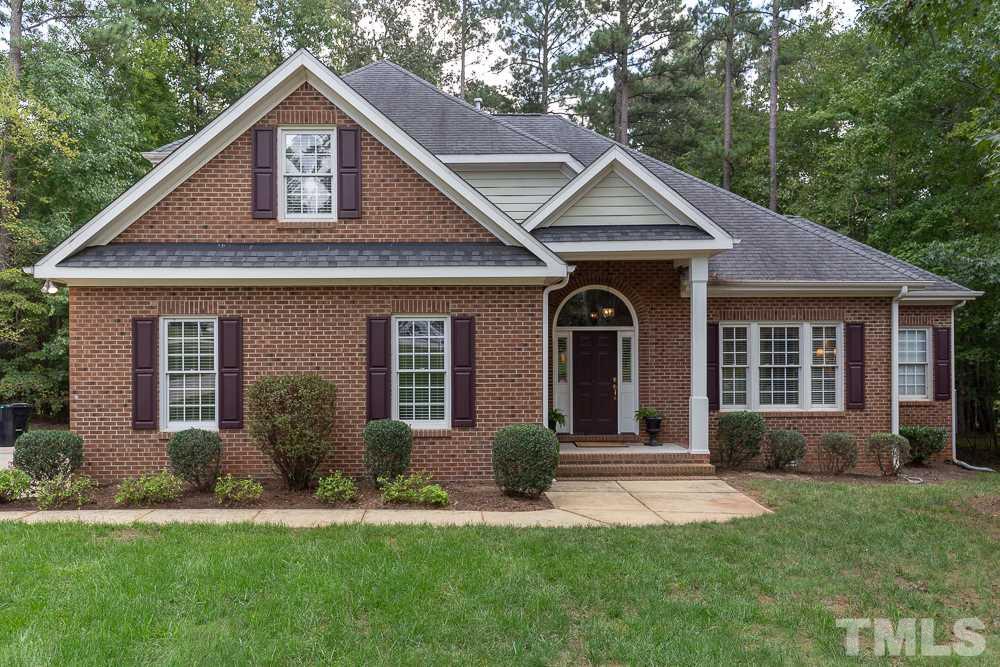 5004 Martin Farm Road Raleigh, NC 27613 - Photo 1 of 25 a front view of a house with a yard and garage