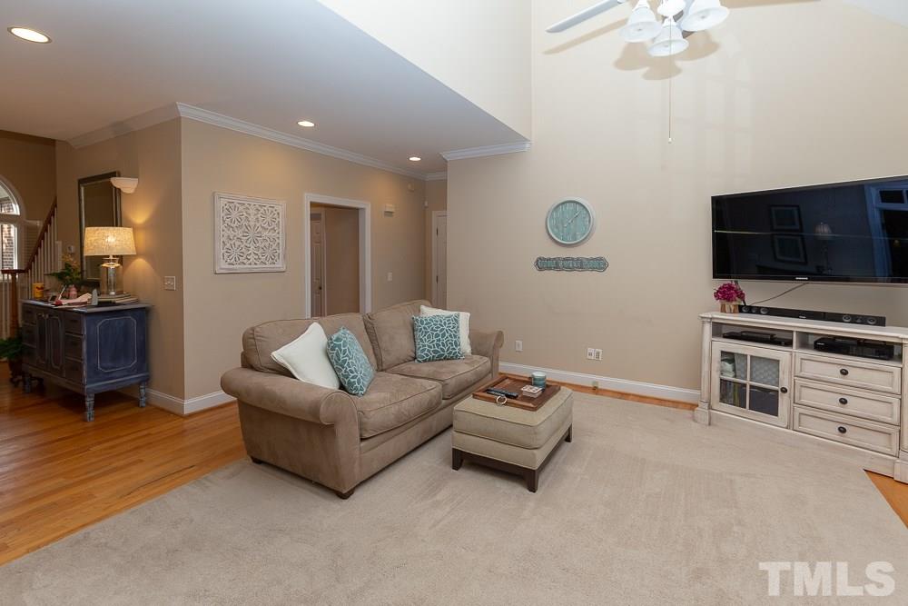 5004 Martin Farm Road Raleigh, NC 27613 - Photo 12 of 25 a living room with furniture and a flat screen tv
