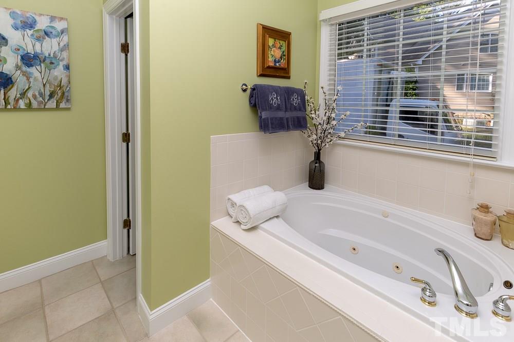 5004 Martin Farm Road Raleigh, NC 27613 - Photo 17 of 25 a bathroom with a tub sink and glass door