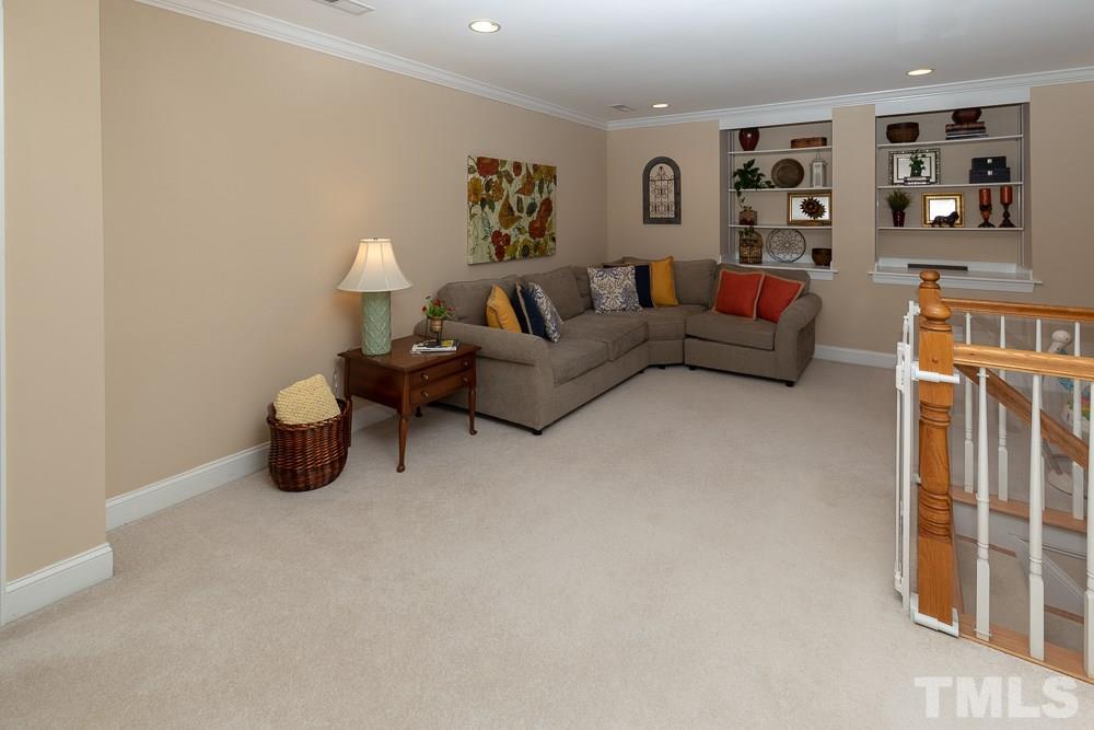 5004 Martin Farm Road Raleigh, NC 27613 - Photo 18 of 25 a living room with furniture and a lamp