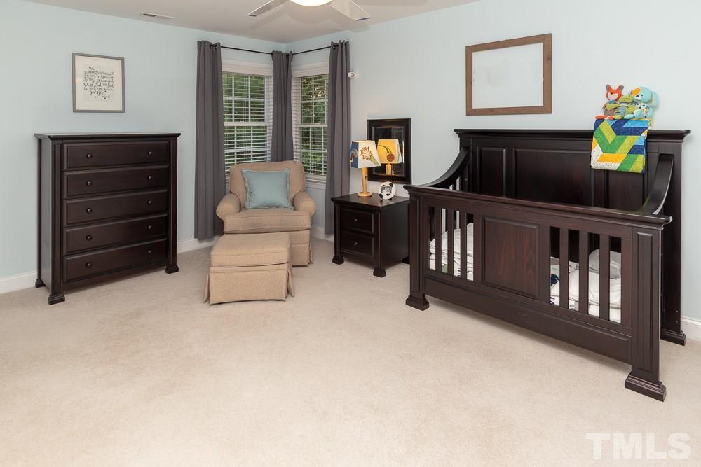 5004 Martin Farm Road Raleigh, NC 27613 - Photo 19 of 25 a living room with furniture and a flat screen tv