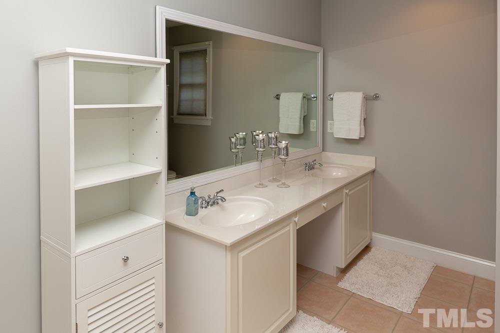 5004 Martin Farm Road Raleigh, NC 27613 - Photo 23 of 25 a bathroom with a sink and a mirror