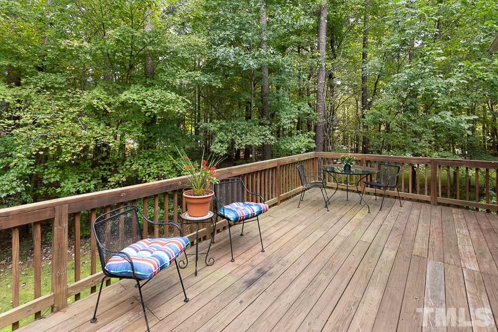 5004 Martin Farm Road Raleigh, NC 27613 - Photo 25 of 25 a balcony with wooden floor and outdoor seating