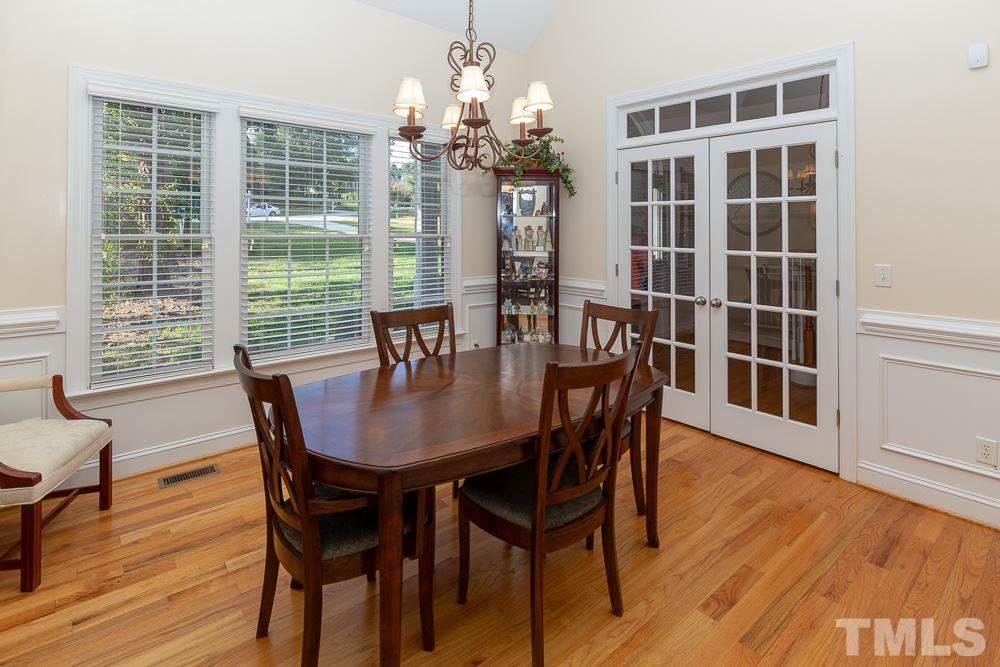 5004 Martin Farm Road Raleigh, NC 27613 - Photo 5 of 25 a view of a dining room with furniture wooden floor and chandelier