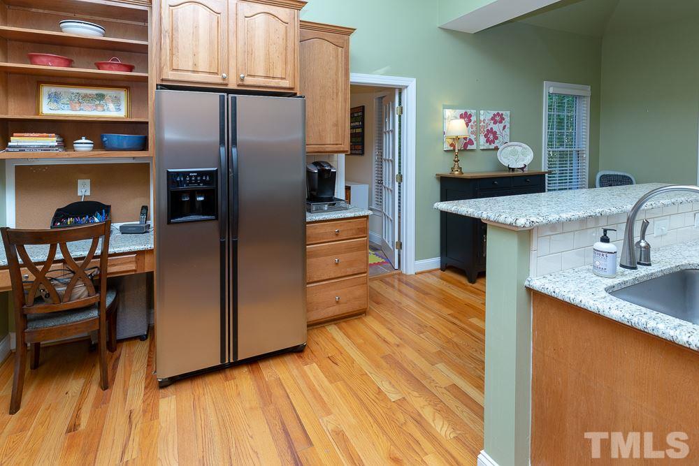5004 Martin Farm Road Raleigh, NC 27613 - Photo 8 of 25 a kitchen with stainless steel appliances granite countertop a refrigerator and a stove