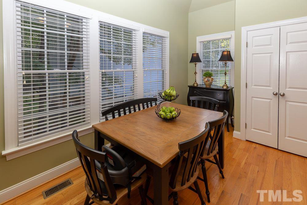 5004 Martin Farm Road Raleigh, NC 27613 - Photo 10 of 25 a view of a dining room with furniture and wooden floor