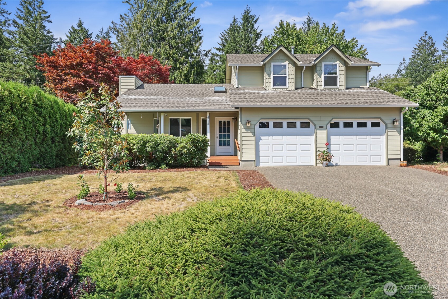 2715 Walnut Loop Northwest Olympia, WA 98502 - Photo 1 of 37 a front view of a house with a yard and garage