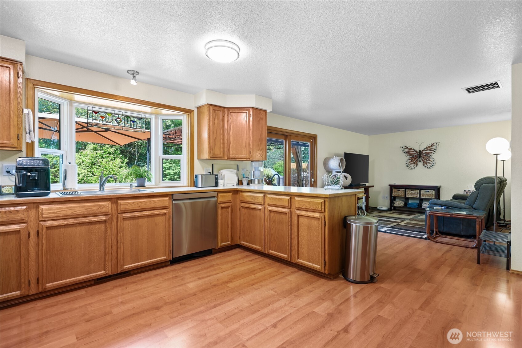 2715 Walnut Loop Northwest Olympia, WA 98502 - Photo 11 of 37 a kitchen with sink cabinets and wooden floor