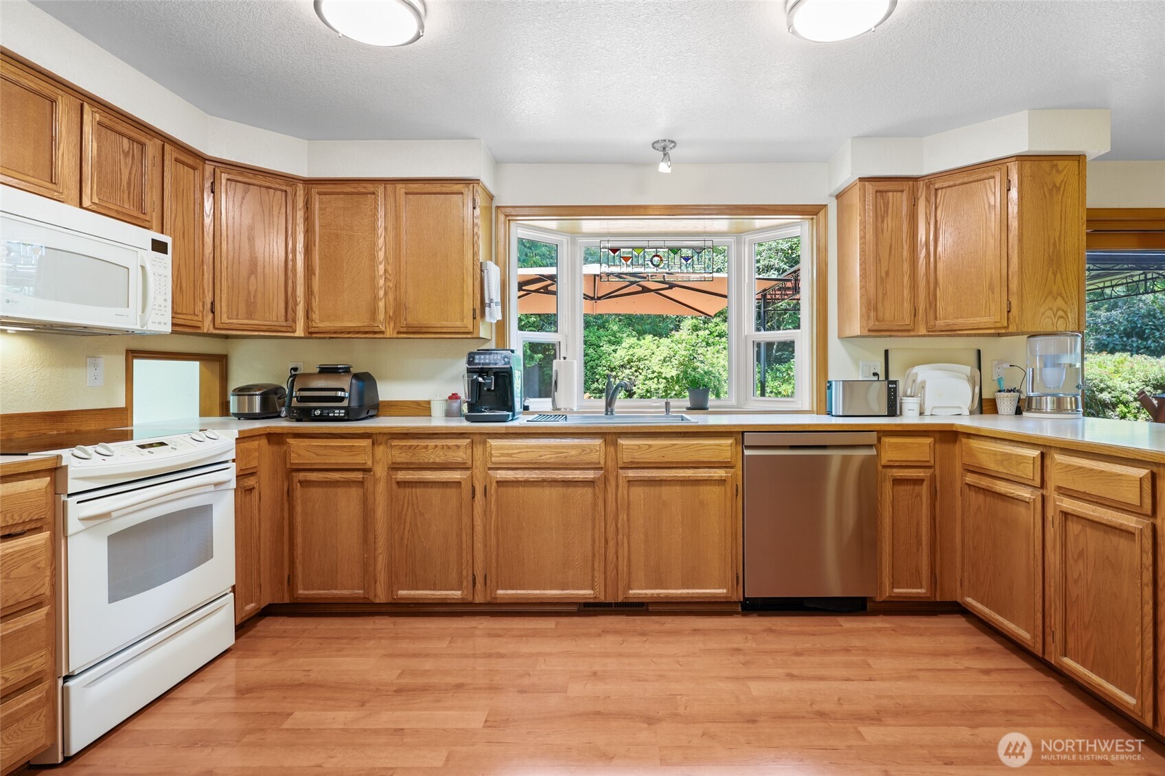 2715 Walnut Loop Northwest Olympia, WA 98502 - Photo 13 of 37 a kitchen with stainless steel appliances granite countertop a stove a sink dishwasher and a refrigerator