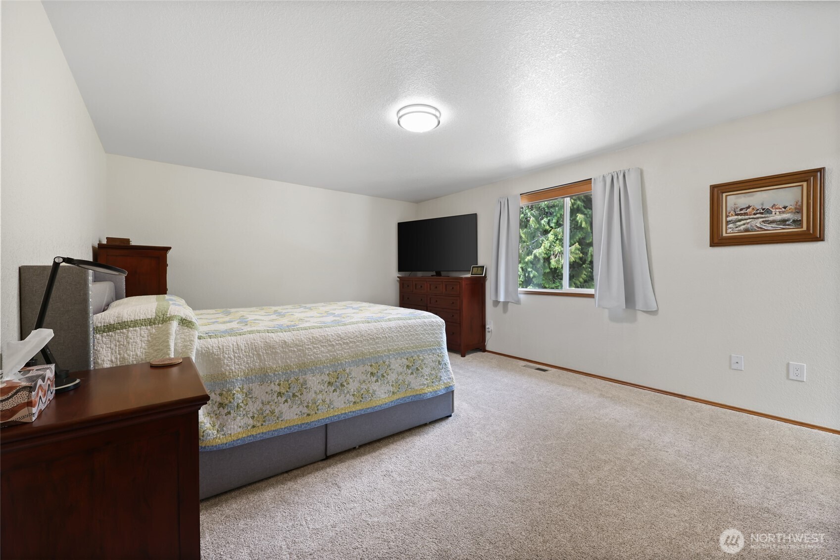 2715 Walnut Loop Northwest Olympia, WA 98502 - Photo 17 of 37 a bedroom with a bed and wooden floor