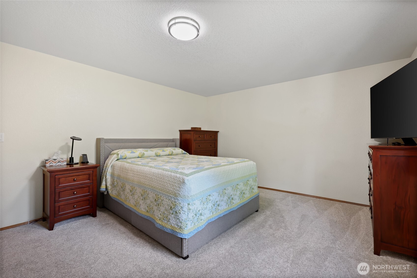 2715 Walnut Loop Northwest Olympia, WA 98502 - Photo 18 of 37 a bedroom with a bed and a flat screen tv