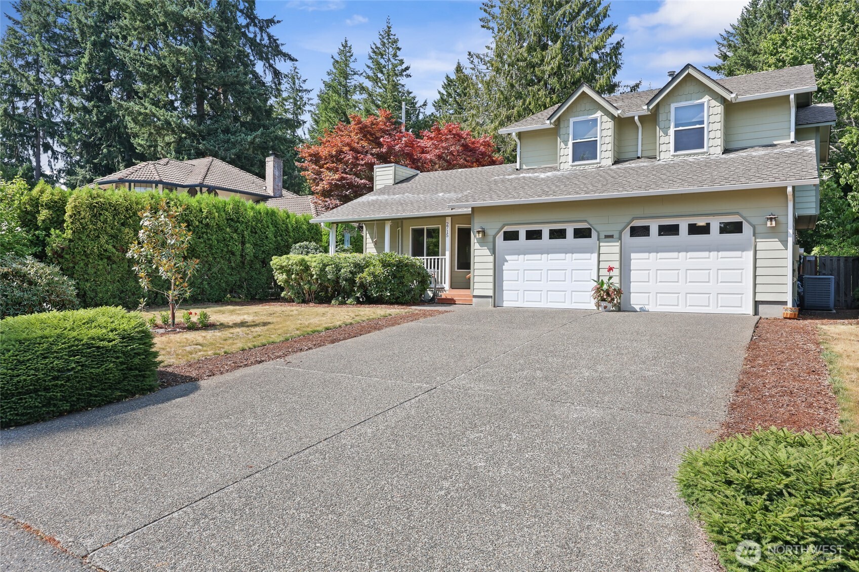 2715 Walnut Loop Northwest Olympia, WA 98502 - Photo 2 of 37 a front view of a house with a yard and garage