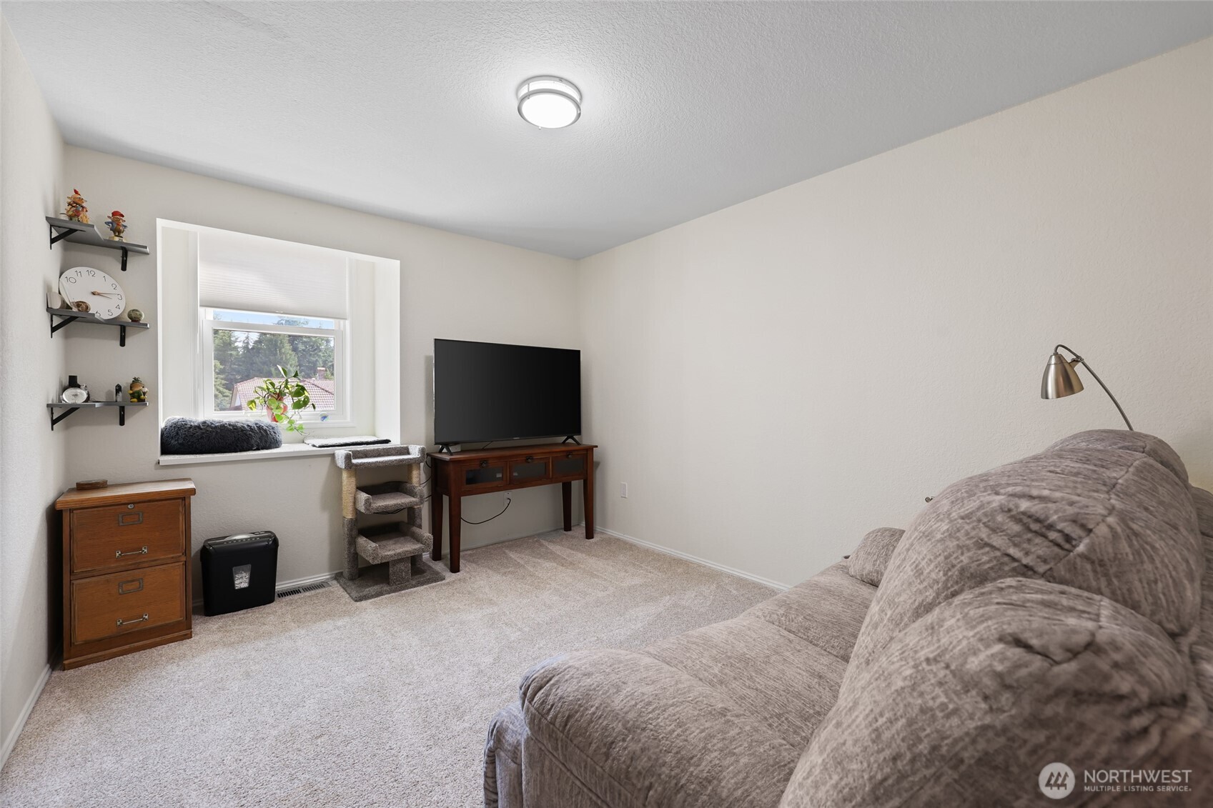 2715 Walnut Loop Northwest Olympia, WA 98502 - Photo 21 of 37 a living room with furniture and a flat screen tv