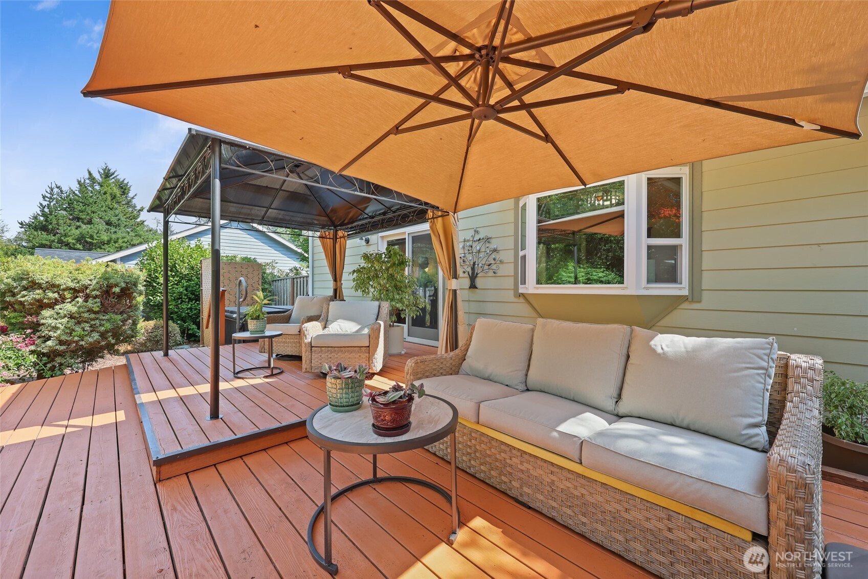 2715 Walnut Loop Northwest Olympia, WA 98502 - Photo 24 of 37 a view of patio with a table and chairs under an umbrella