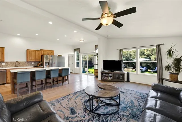 a kitchen with stainless steel appliances granite countertop a refrigerator a stove and a sink