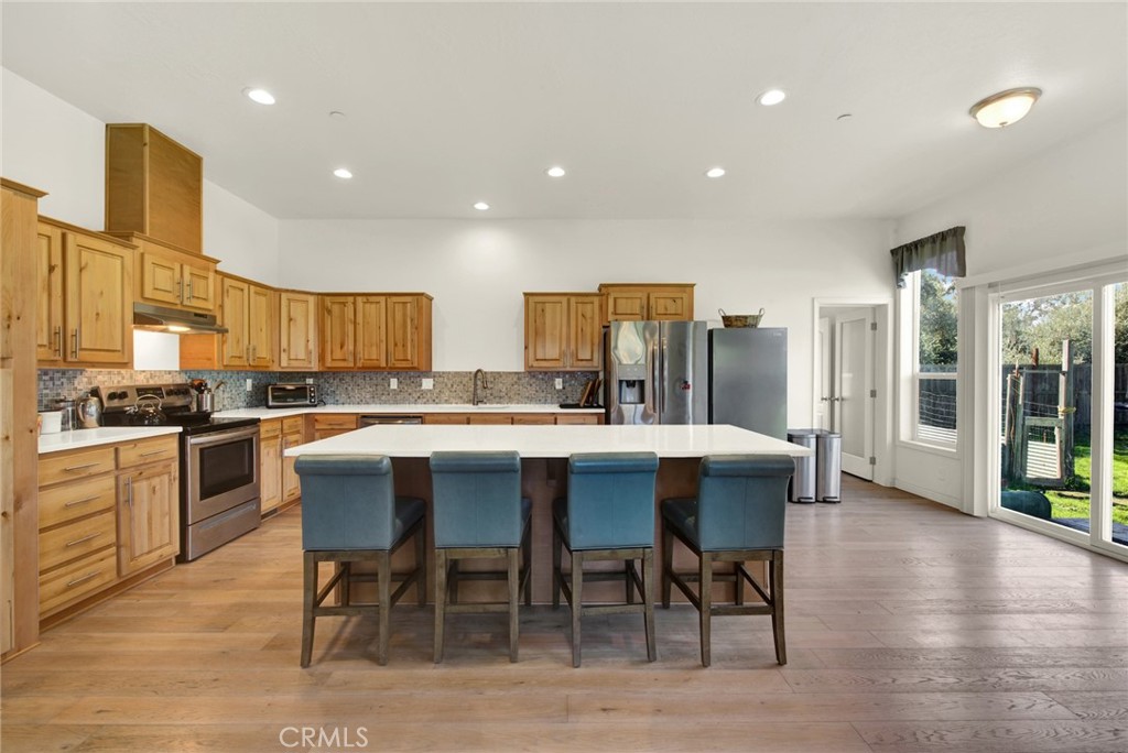 23580 Loleta Avenue Corning, CA 96021 - Photo 22 of 70 a kitchen with a dining table chairs and wooden floor