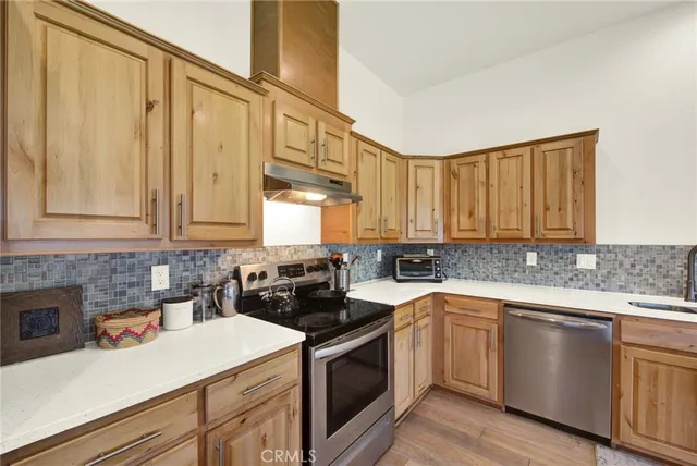 a view of kitchen with refrigerator and wooden floor