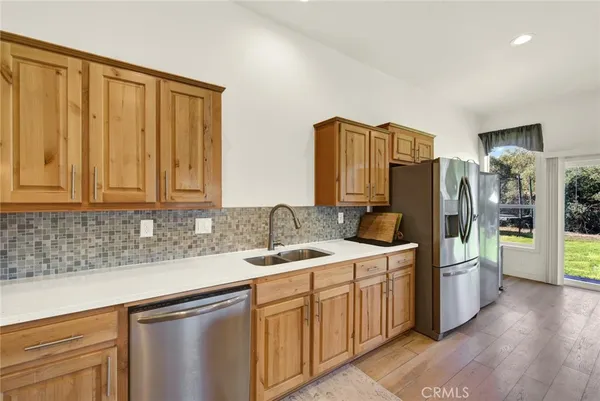 a view of a kitchen with fridge and rack