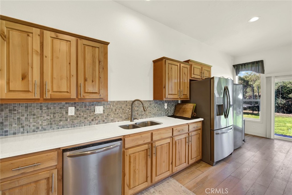 23580 Loleta Avenue Corning, CA 96021 - Photo 25 of 70 a kitchen that has a sink a refrigerator and a stove top oven