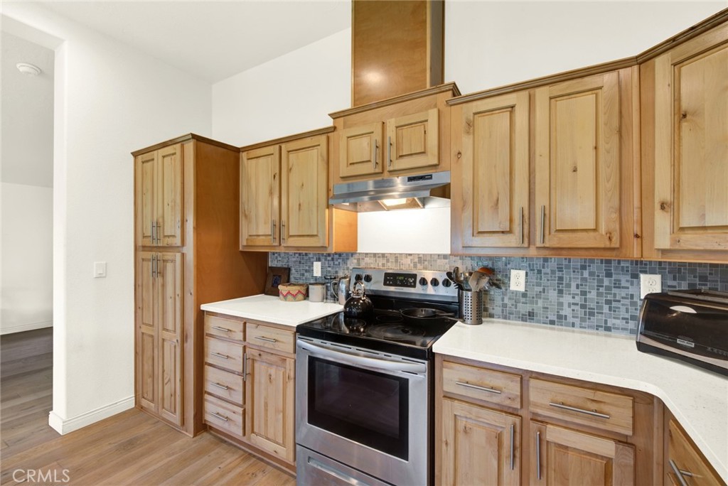 23580 Loleta Avenue Corning, CA 96021 - Photo 26 of 70 a kitchen with stainless steel appliances granite countertop a stove a sink and a refrigerator