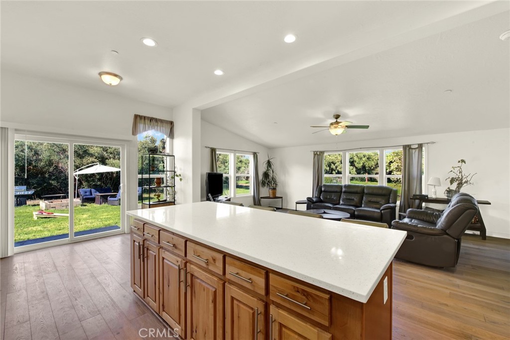 23580 Loleta Avenue Corning, CA 96021 - Photo 27 of 70 a view of a kitchen with kitchen island a large window cabinets a sink and stainless steel appliances