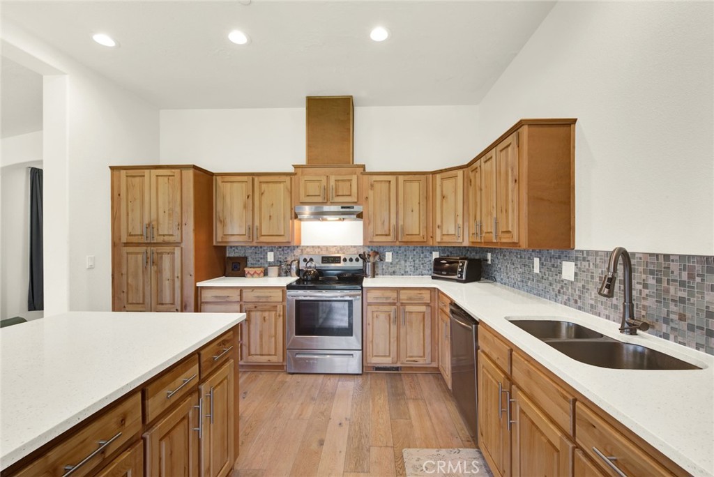 23580 Loleta Avenue Corning, CA 96021 - Photo 28 of 70 a kitchen with a sink a stove and cabinets