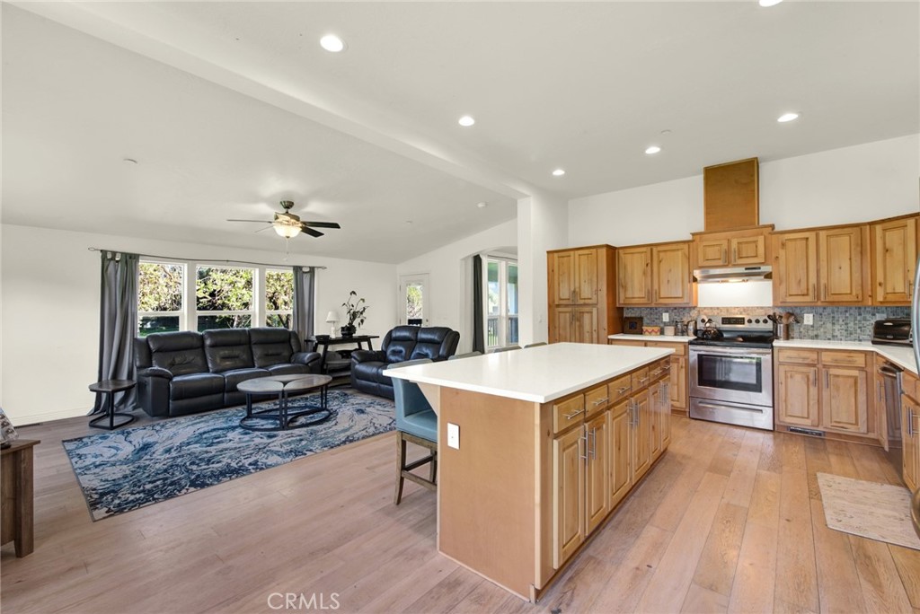 23580 Loleta Avenue Corning, CA 96021 - Photo 29 of 70 a large kitchen with kitchen island a large counter top a sink a stove a refrigerator and cabinets