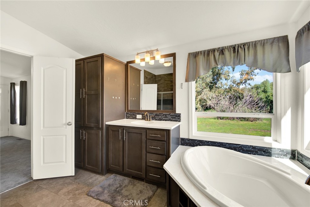 23580 Loleta Avenue Corning, CA 96021 - Photo 40 of 70 a bathroom with a tub sink and mirror