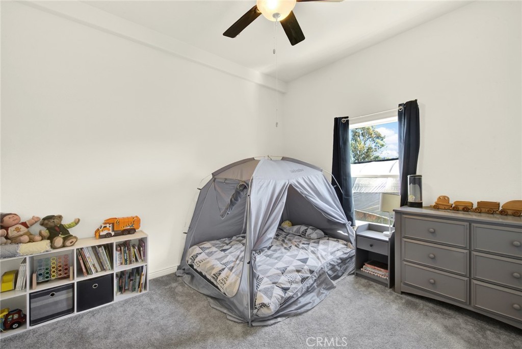 23580 Loleta Avenue Corning, CA 96021 - Photo 42 of 70 a bedroom with furniture and a window