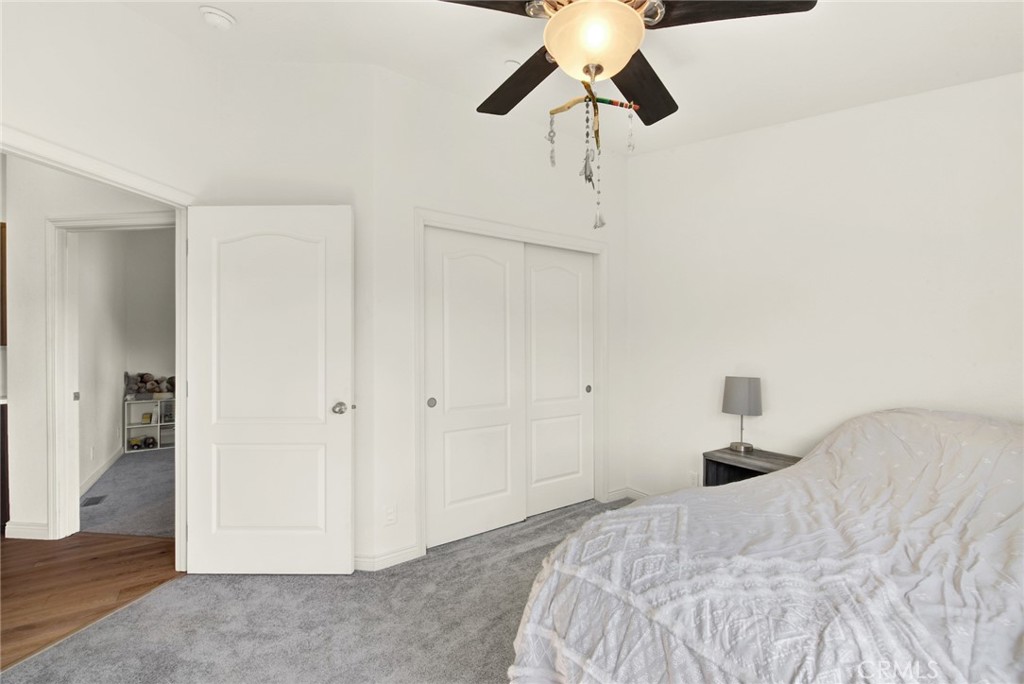 23580 Loleta Avenue Corning, CA 96021 - Photo 46 of 70 a bedroom with a bed and a chandelier