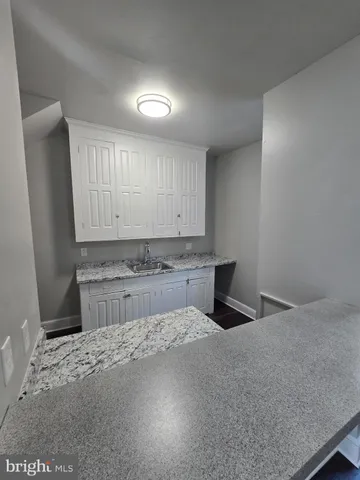 a kitchen with a sink a stove and cabinets