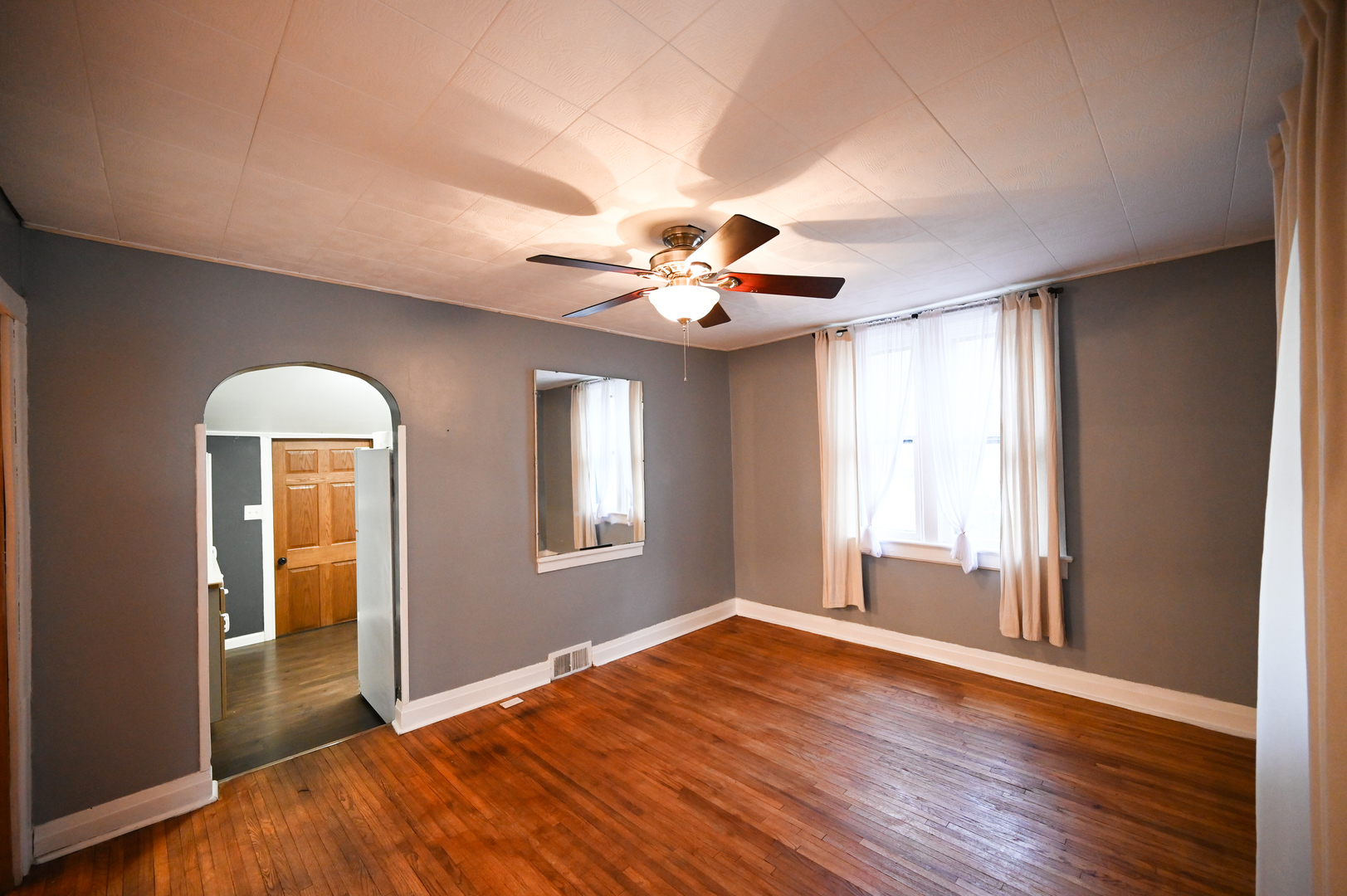 219 South 7th Street DeKalb, IL 60115 - Photo 5 of 30 a view of empty room with wooden floor and fan