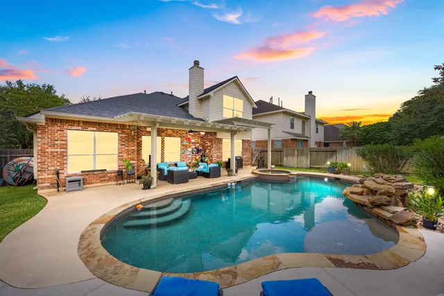 a view of a house with swimming pool and porch