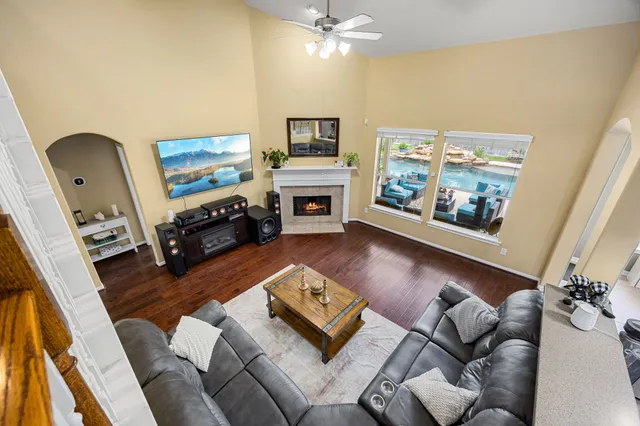 a living room with furniture fireplace and flat screen tv