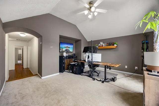 a view of a livingroom with workspace and a window