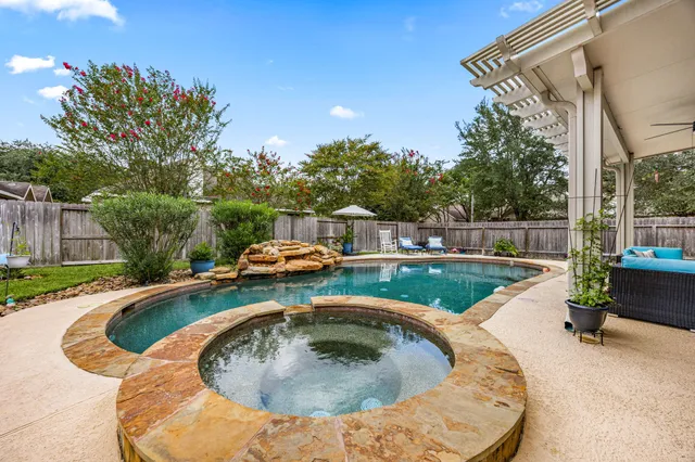 a swimming pool with outdoor seating and yard