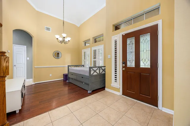 a living room with a large mirror and furniture