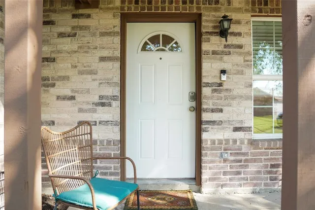 a view of a balcony with a table and chairs