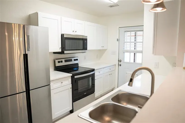 a kitchen with a refrigerator sink and microwave