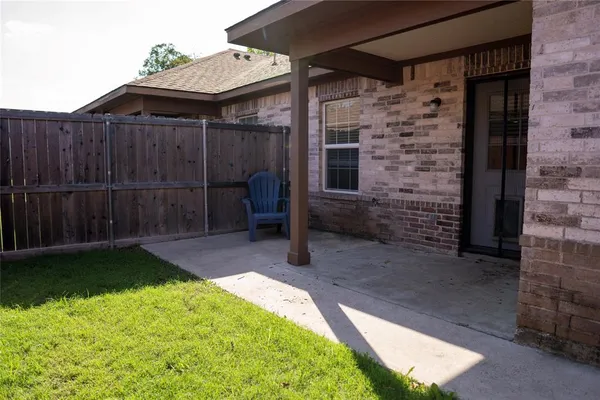 a backyard of a house with barbeque oven