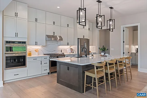a kitchen with stainless steel appliances granite countertop a stove and white cabinets