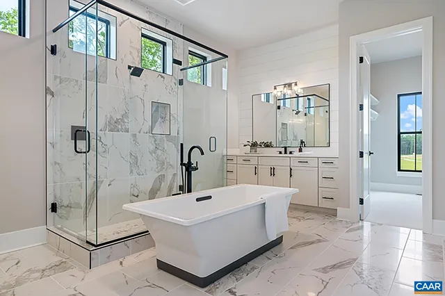 a bathroom with a tub a sink and mirror