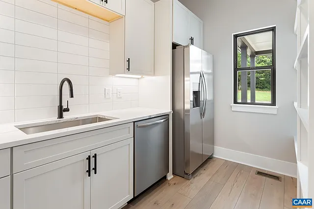 a kitchen with a refrigerator and a sink
