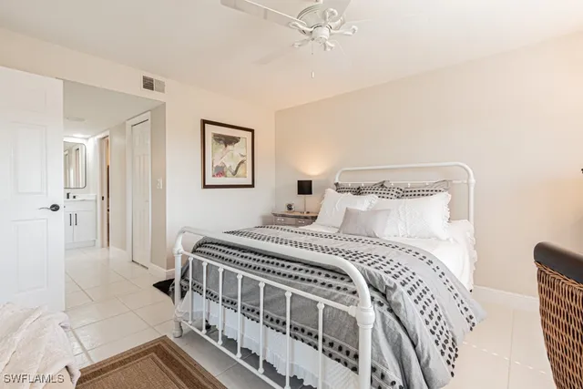 a bedroom with a bed and a painting on the wall