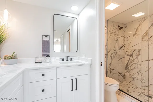 a bathroom with double vanity sinks and a mirror