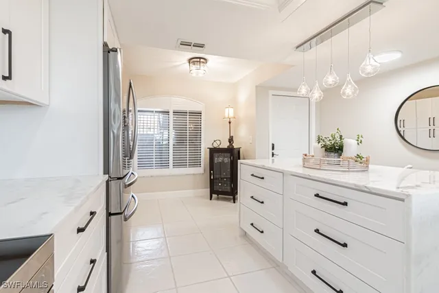 a spacious bathroom with a granite countertop sink mirror and bathtub