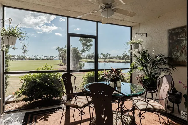a view of a balcony with table and chairs and potted plants