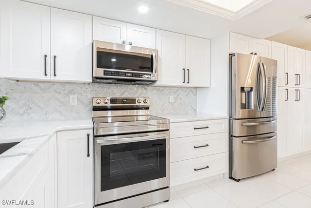 a kitchen with granite countertop a sink and steel appliances