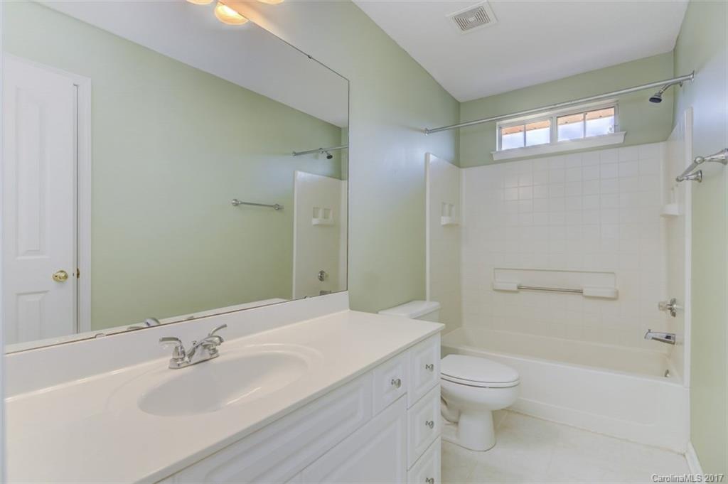 12206 Marathon Hill Road Charlotte, NC 28269 - Photo 12 of 23 a bathroom with a sink a toilet and shower