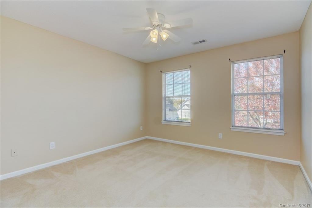 12206 Marathon Hill Road Charlotte, NC 28269 - Photo 13 of 23 an empty room with windows and fan